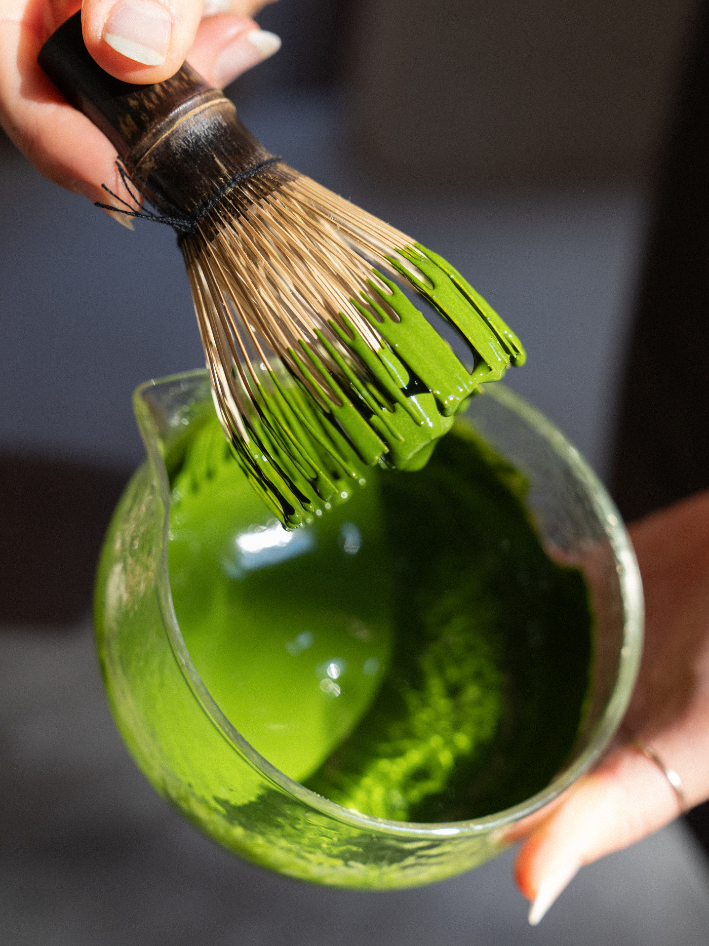 Ceremonial matcha whisked in a glass spouted bowl