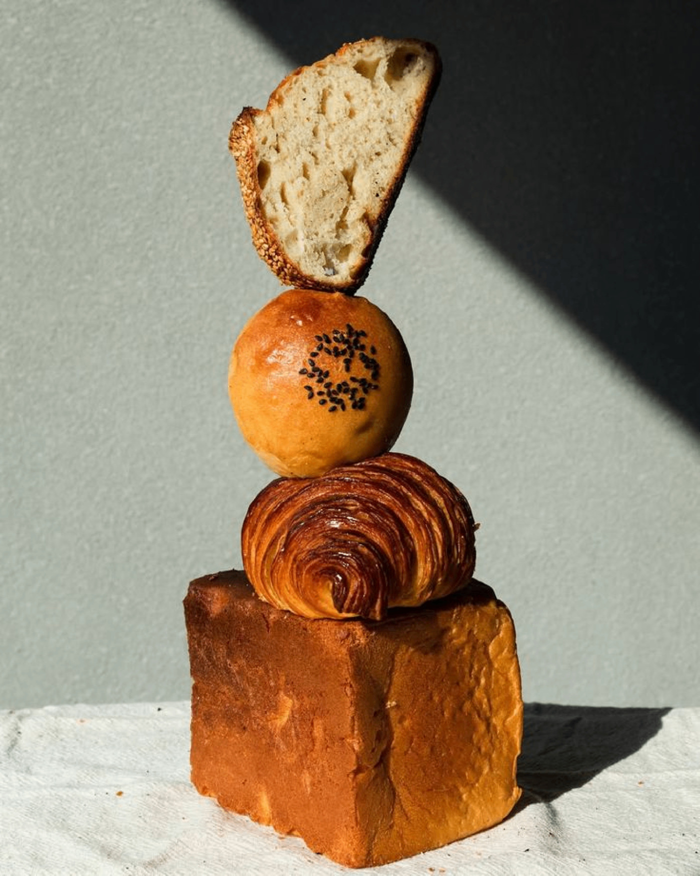 Sculptural stack of bread, brioche, croissant and shokupan